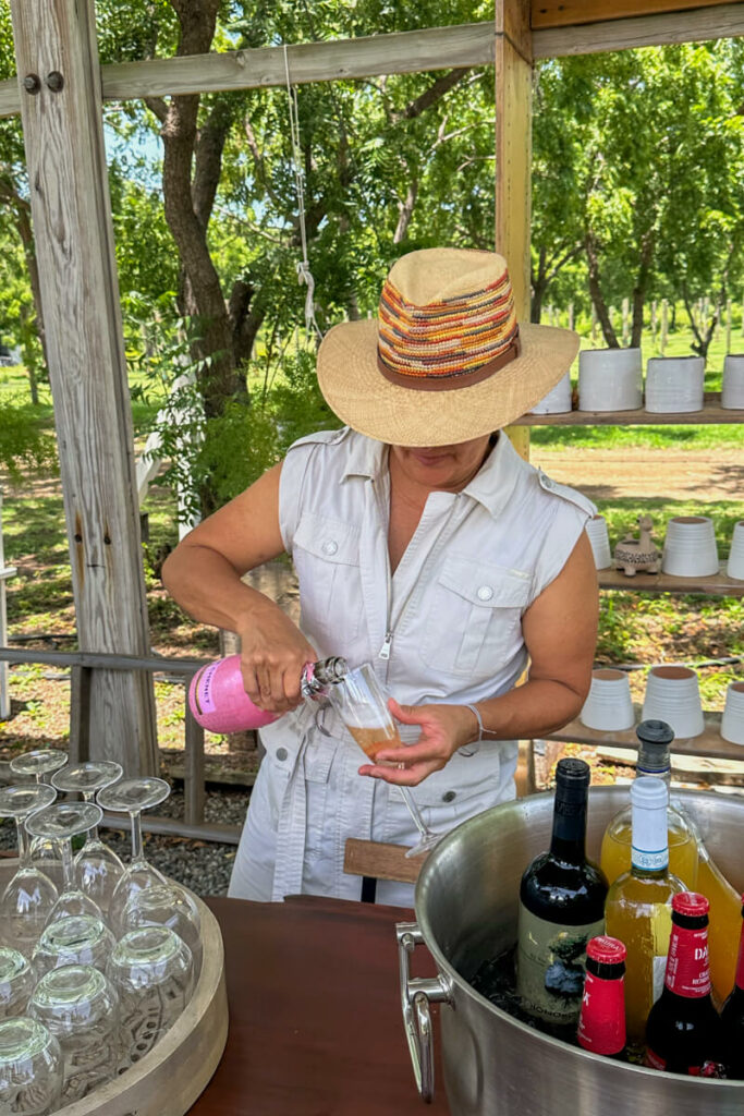 Hacienda Tahiti Verde owner pouring a glass of champagne for a guest