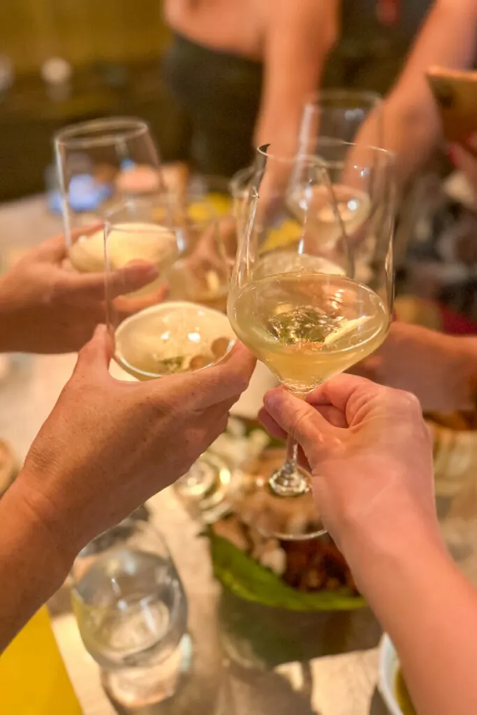 Cheers with wine glasses and a bubbly champagne