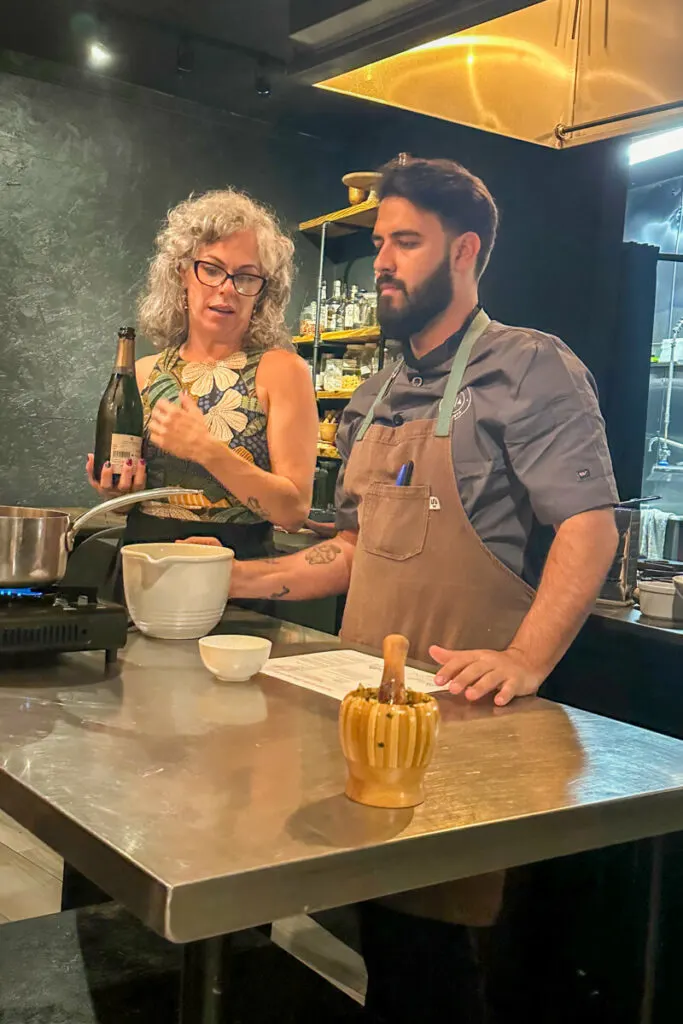 Casa Abierta owner and Chef Manuel standing at a table