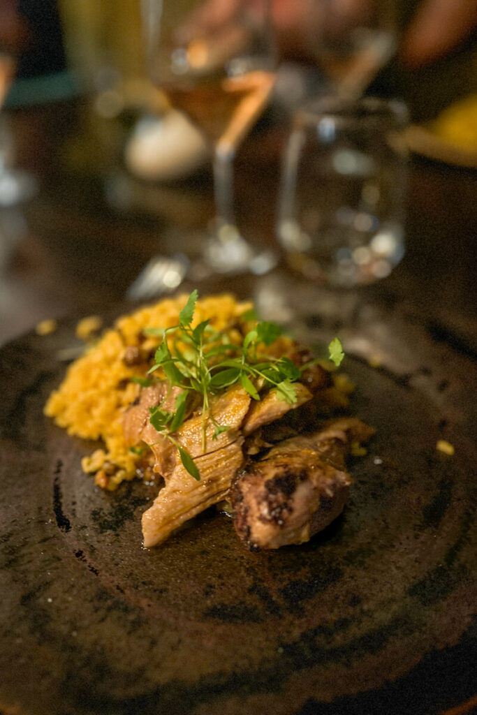 A plate of Puerto Rican authentic food, pork, rice, and pasteles.