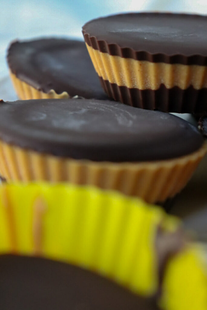 A front side view of a stack of low carb peanut butter cups on a white plate