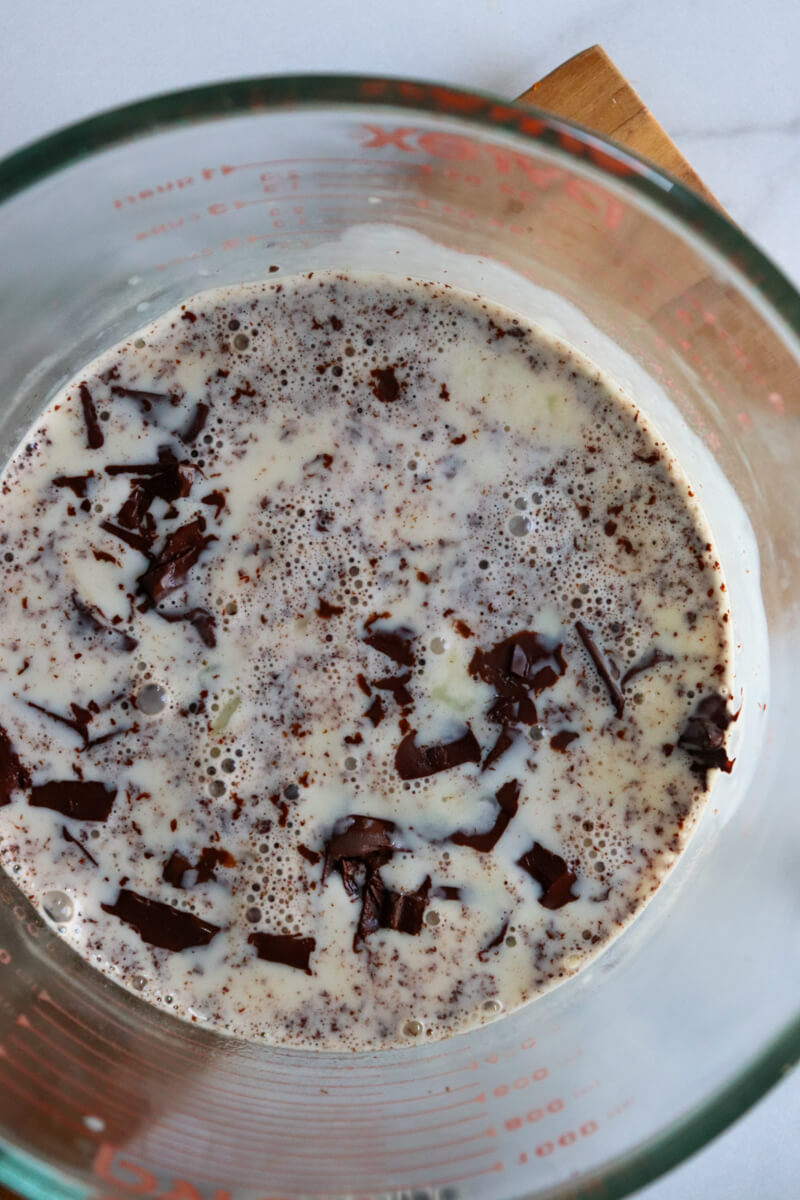Overhead view of the warmed cream melting the chopped chocolate.