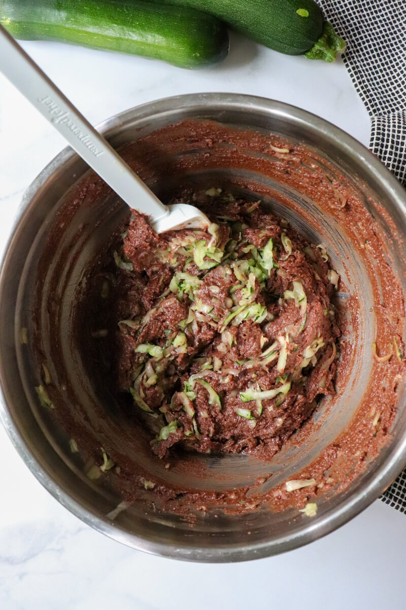 Overhead view of the low carb chocolate batter with the grated zucchini being stirred in.