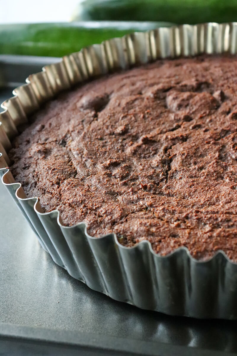 Keto chocolate zucchini cake, still in the fluted metal pan.