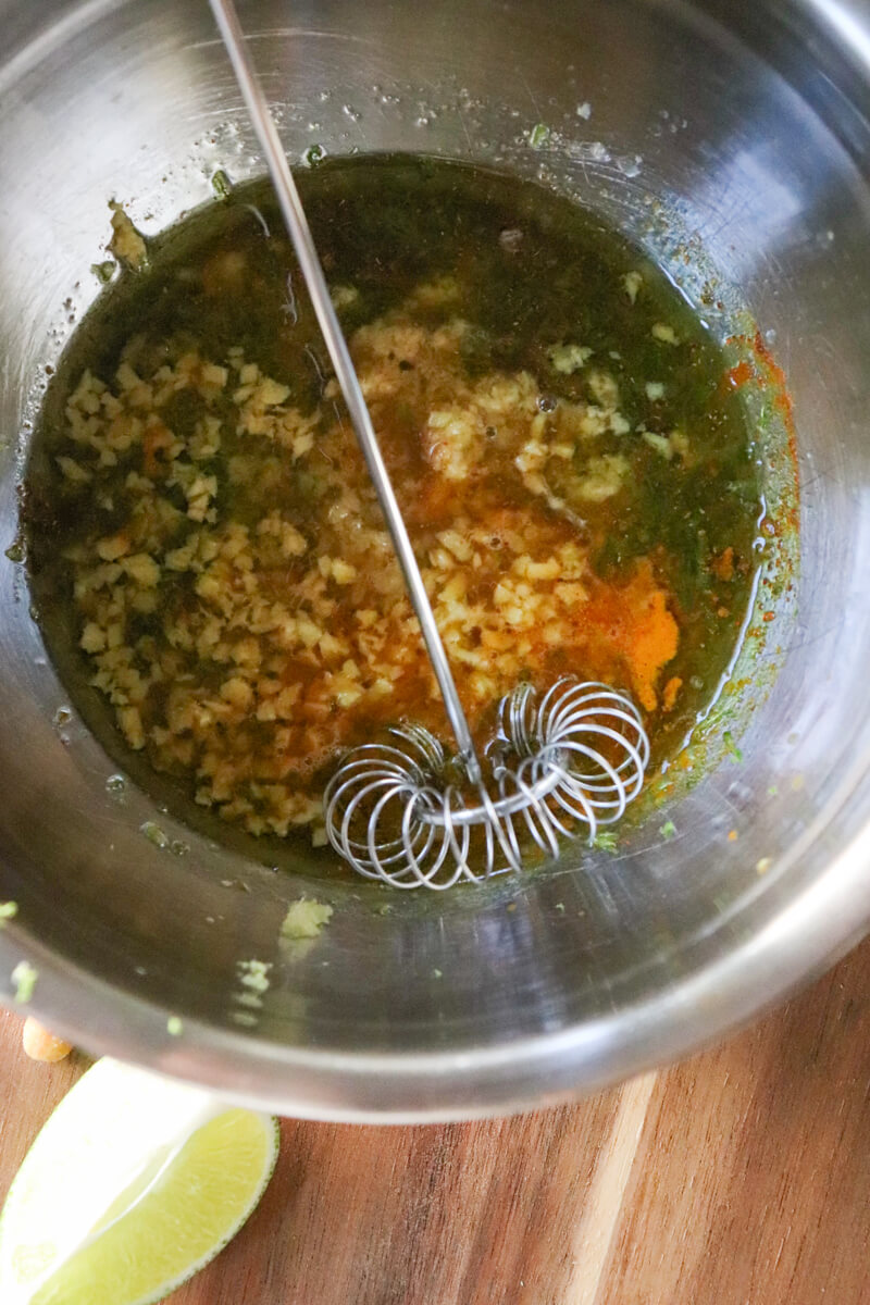 Thai chicken satay marinade in a metal bowl and whisk