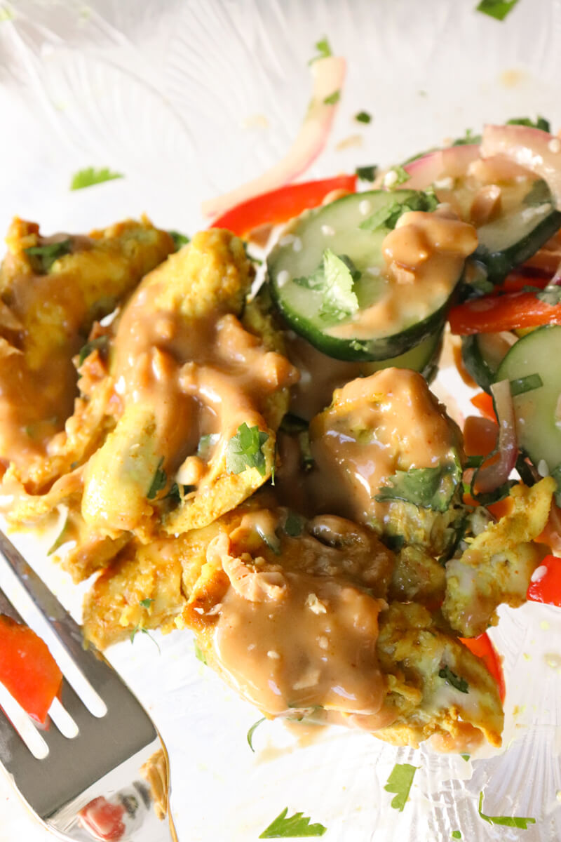 Chicken satay off the skewers with Thai cucumber salad and peanut sauce