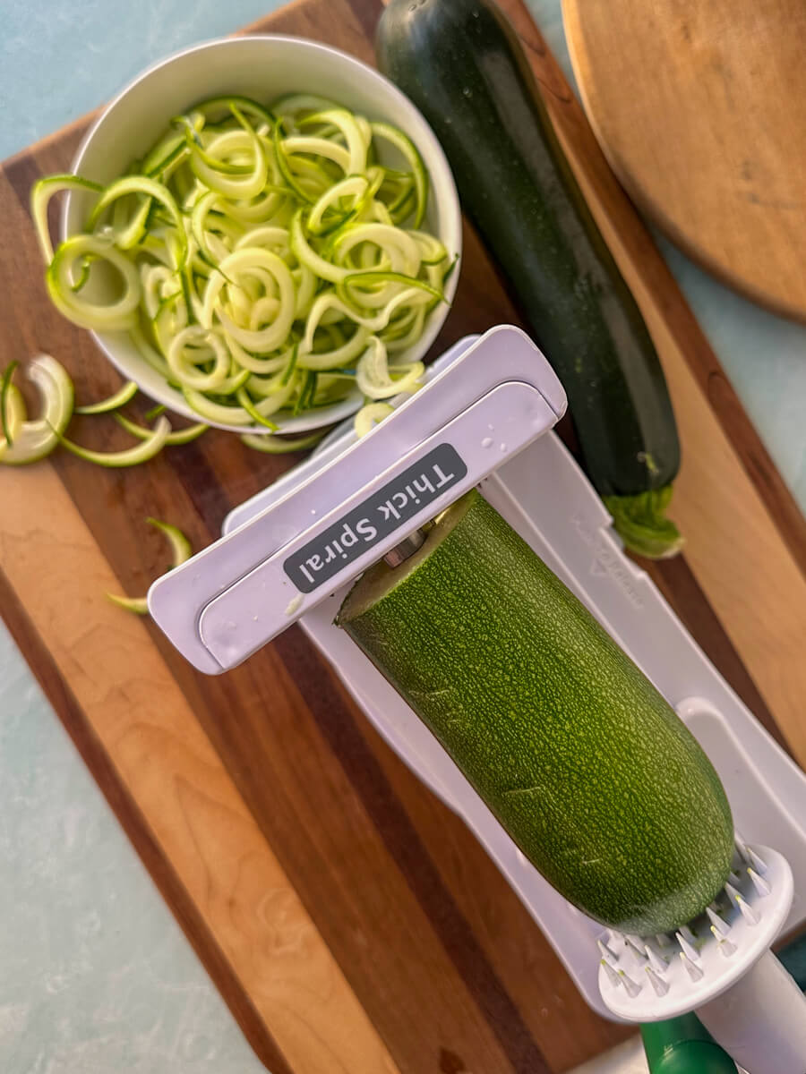 Overhead view of a metal bowl of spiralized zucchini noodles