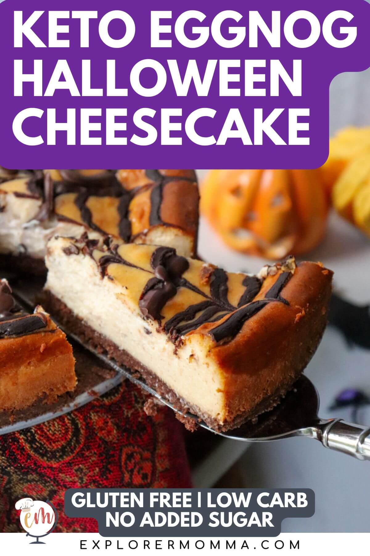 A piece being taken out of a keto eggnog cheesecake with a chocolate spider web perfect for Halloween
