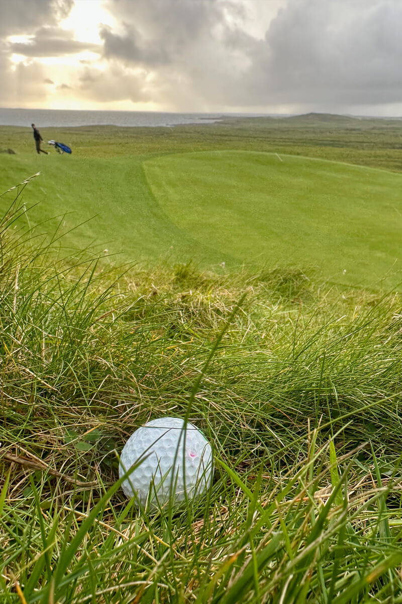 A view of a golf club next to the green.