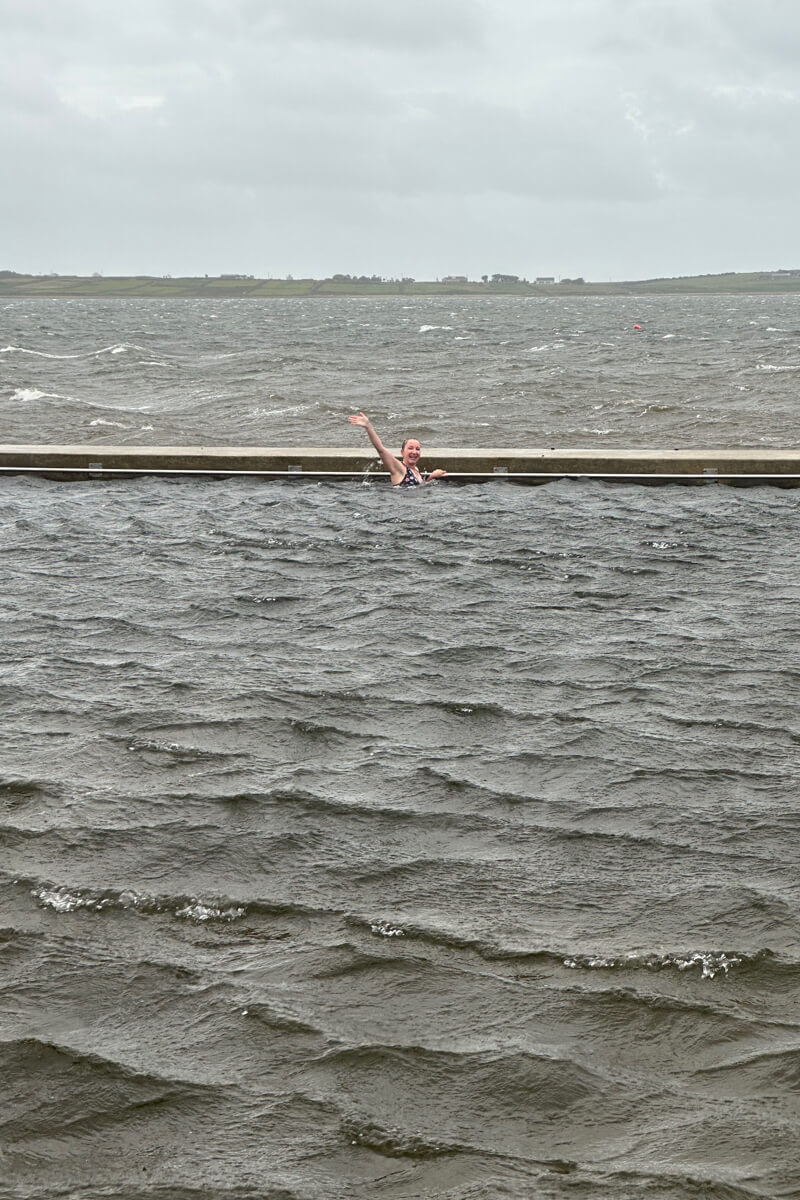 Lauren waving from the other side of the Belmullet Tidal Pool.
