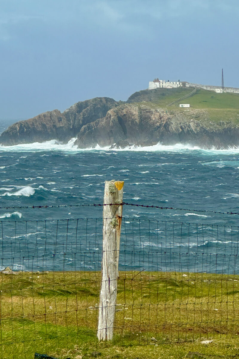 A view from the shore of Eagle Island with the lighthouse perched on the hill.