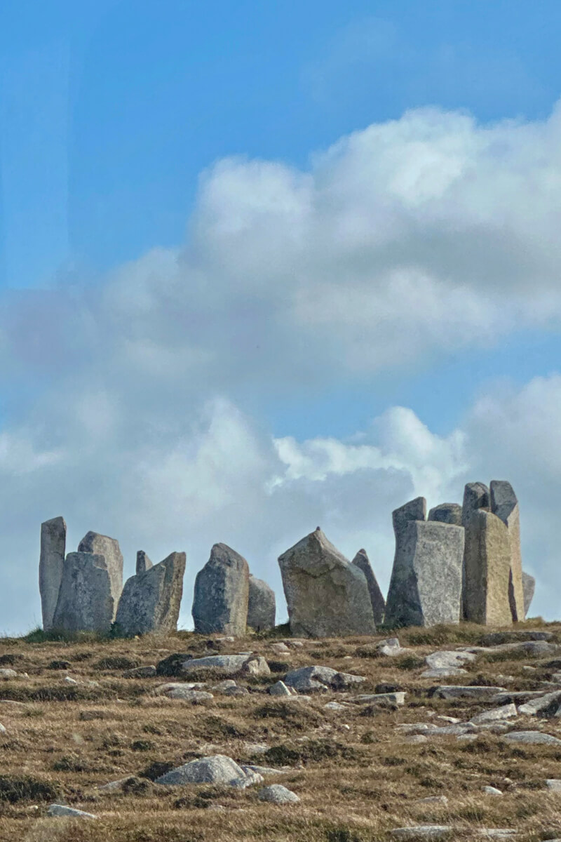 A group of standing stones with clouds in the background in Fallmore, Ireland.
