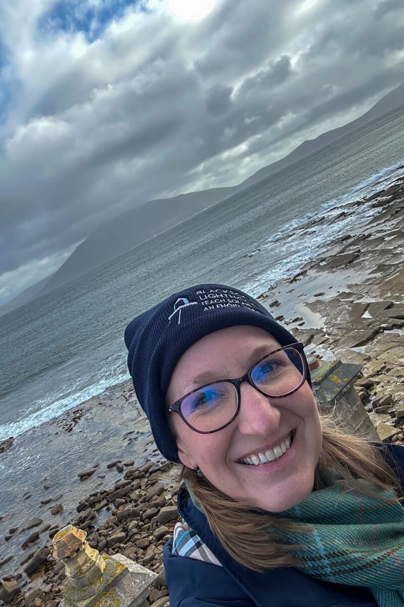 Lauren in front of a beach and islands in the water