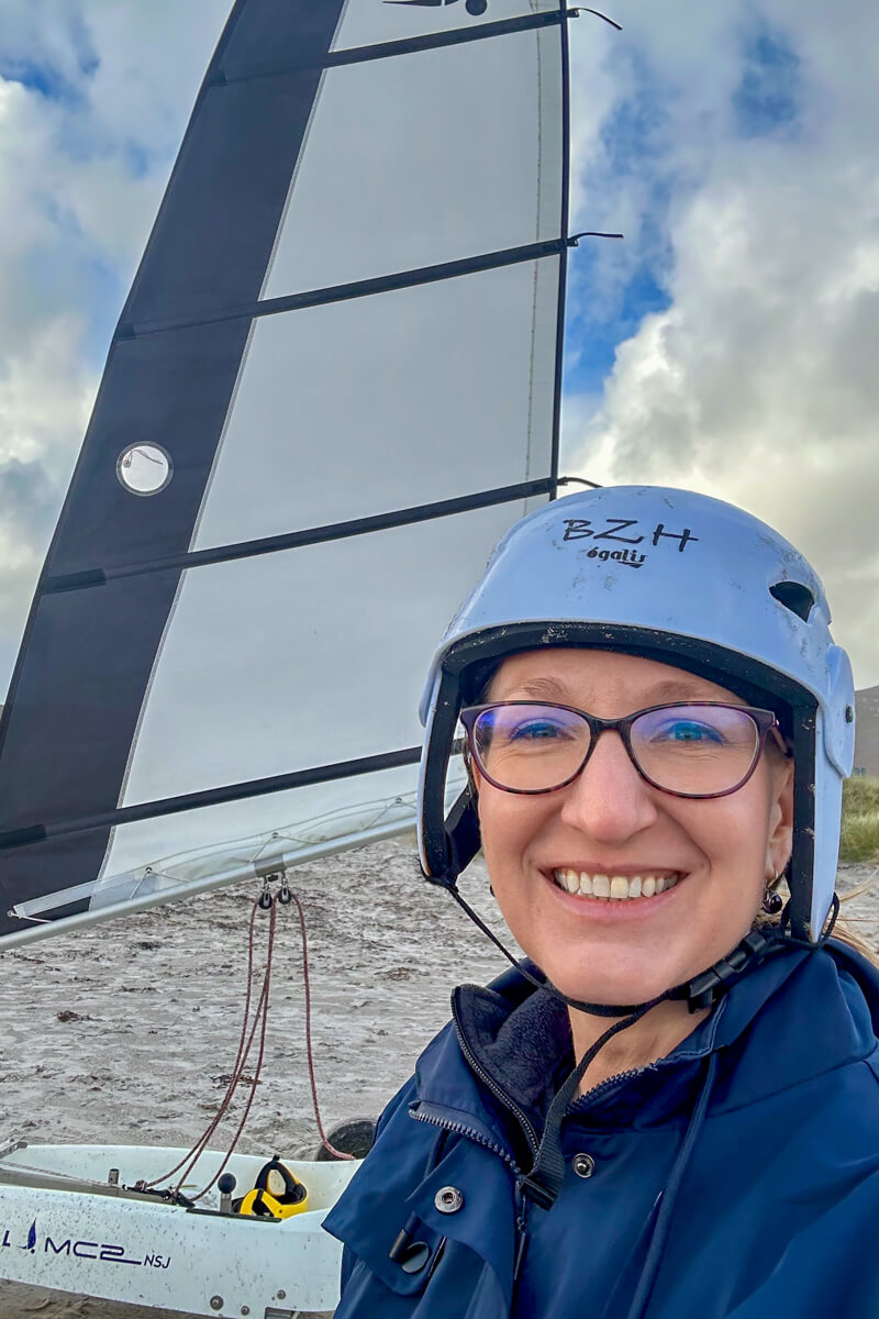 Lauren in a white helmet in front of a land sail
