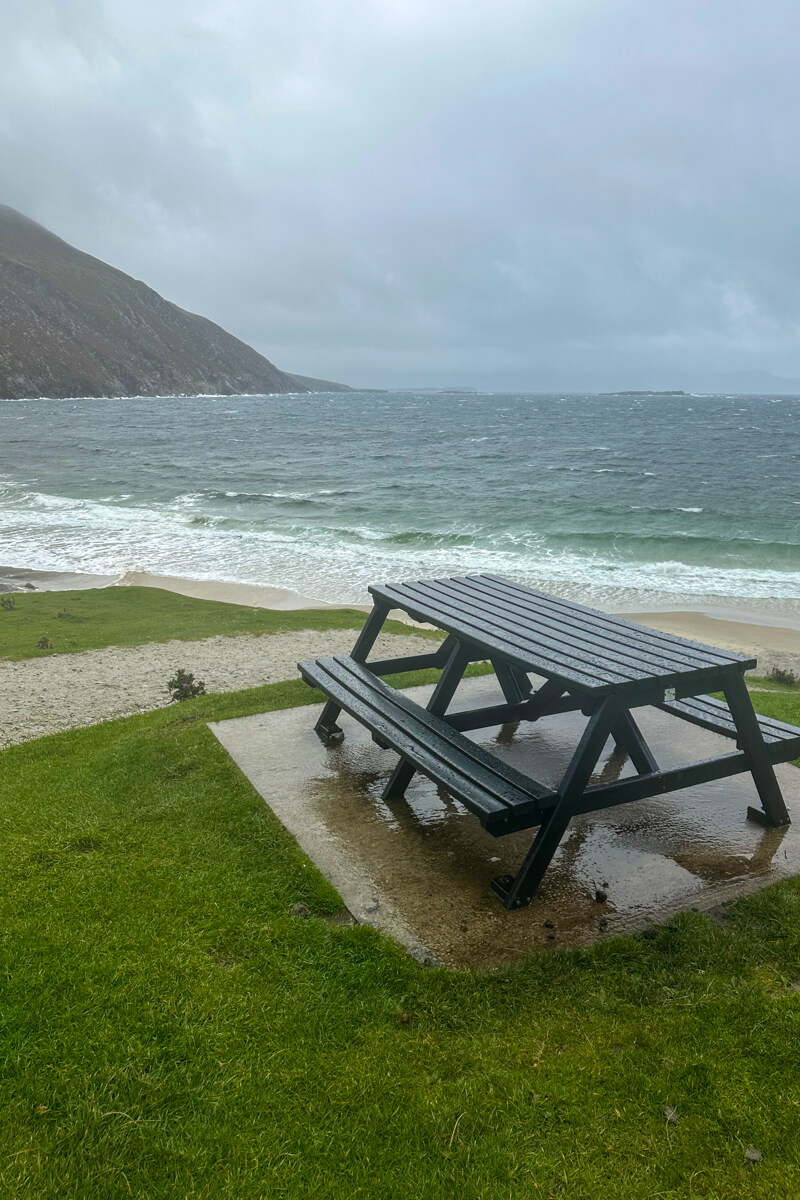 A picnic table on the hill above Keem Beach