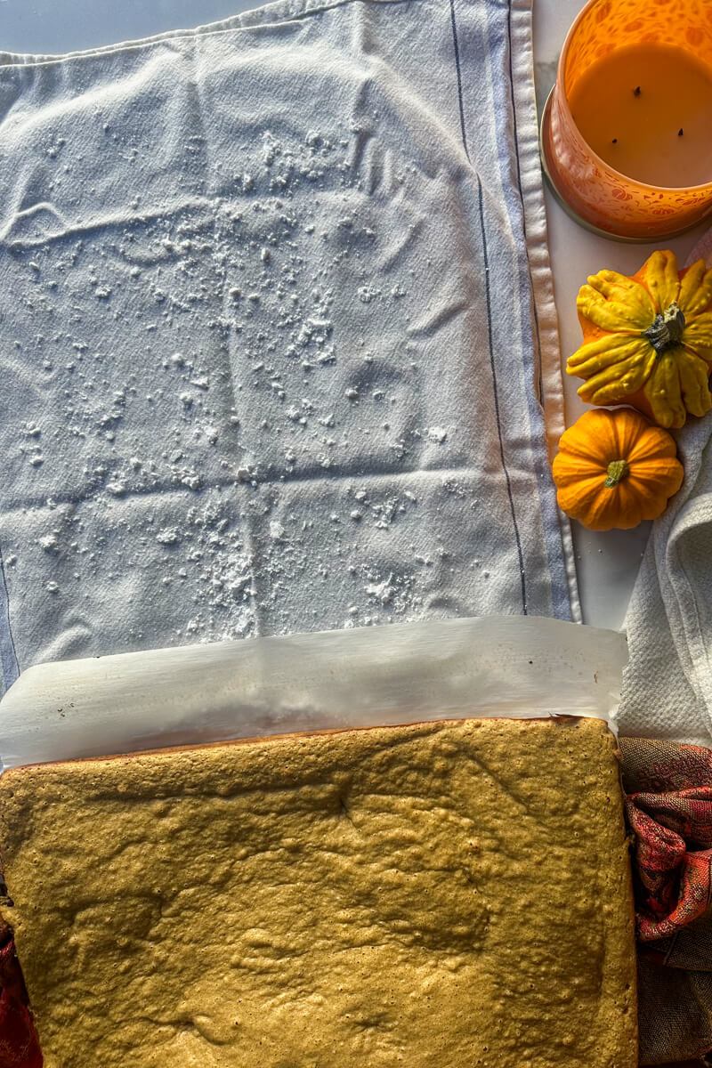 Tea towel with sweetener next to the sponge cake ready to be rolled