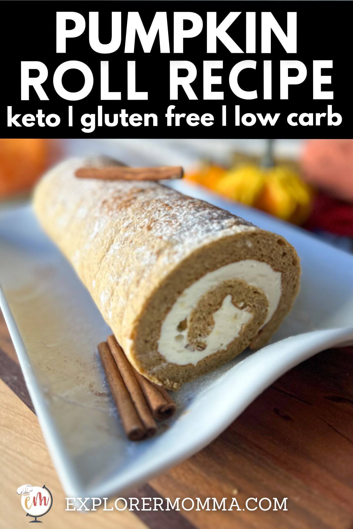 Full no sugar pumpkin roll on a wooden board with cream cheese swirl showing, surrounded by fall decor and a cup of coffee. Text overlay reads “Pumpkin Roll Recipe – Keto, Gluten Free, Low Carb.”