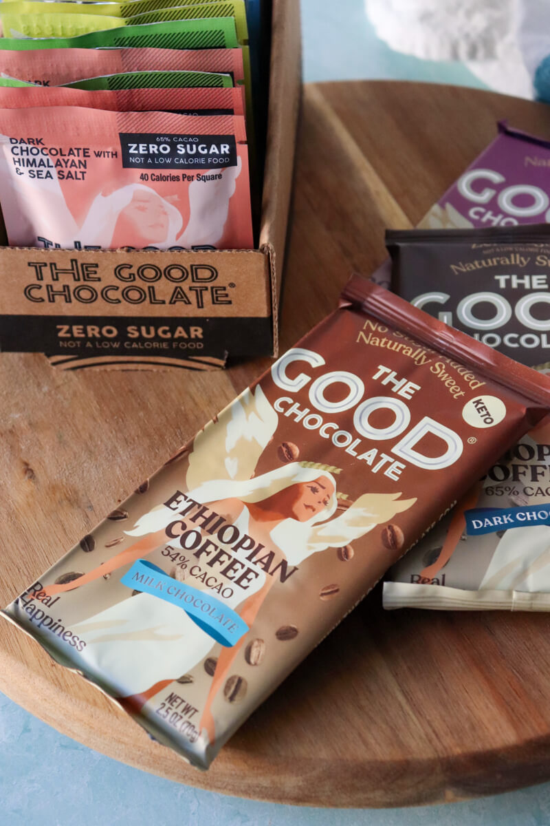 Front view of three The Good Chocolate bars and a box of individually wrapped squares