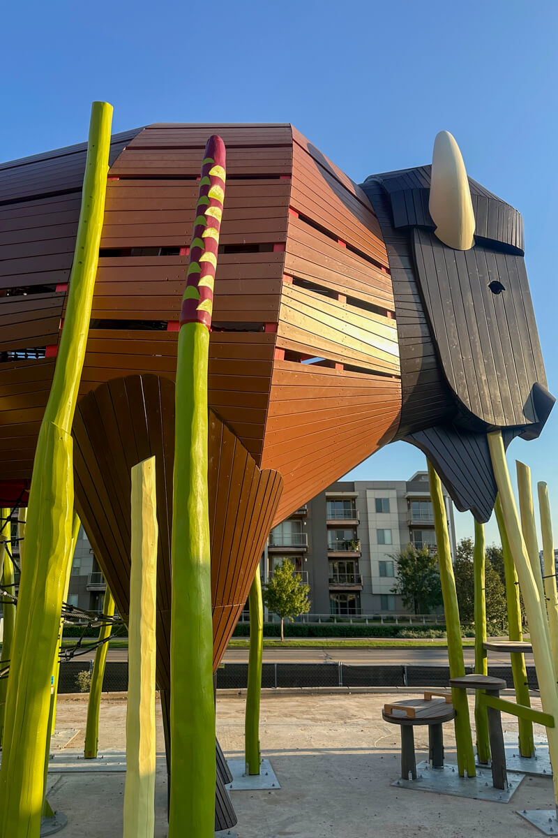 A large play area bison with a building in the background