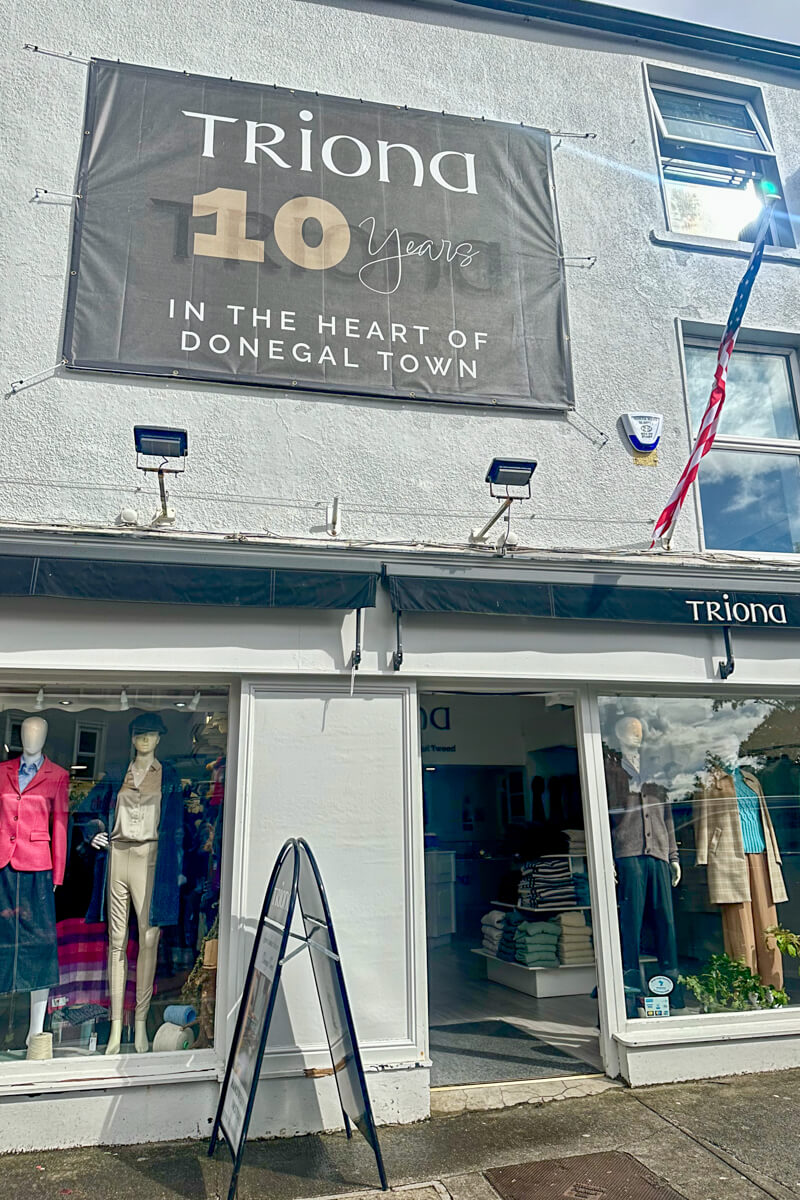 The white store front of Triona with mannequins in the front windows.