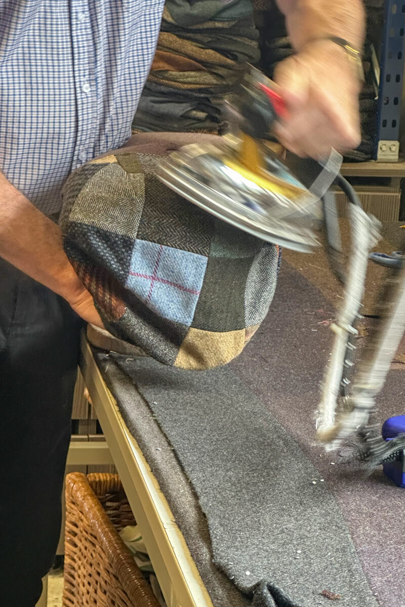 A man ironing a patchwork Hanna Hat