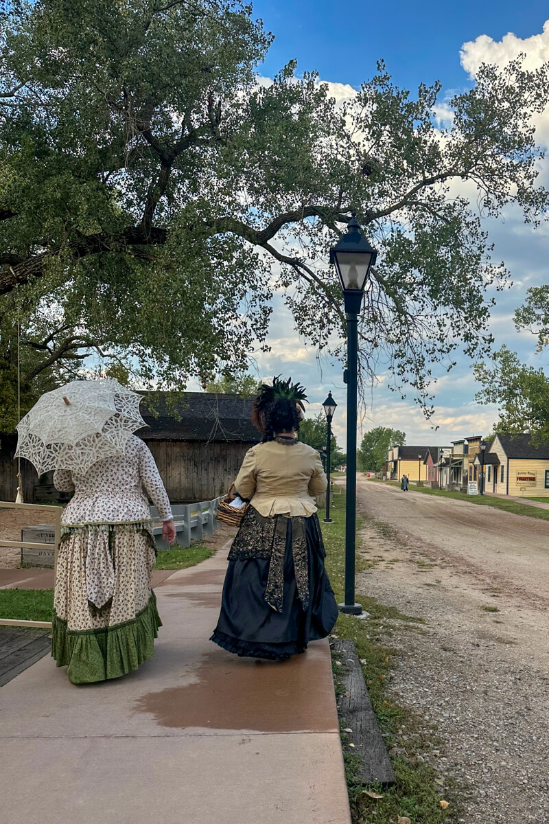 Two ladies in vintage dresses walking down the street in Cowtown