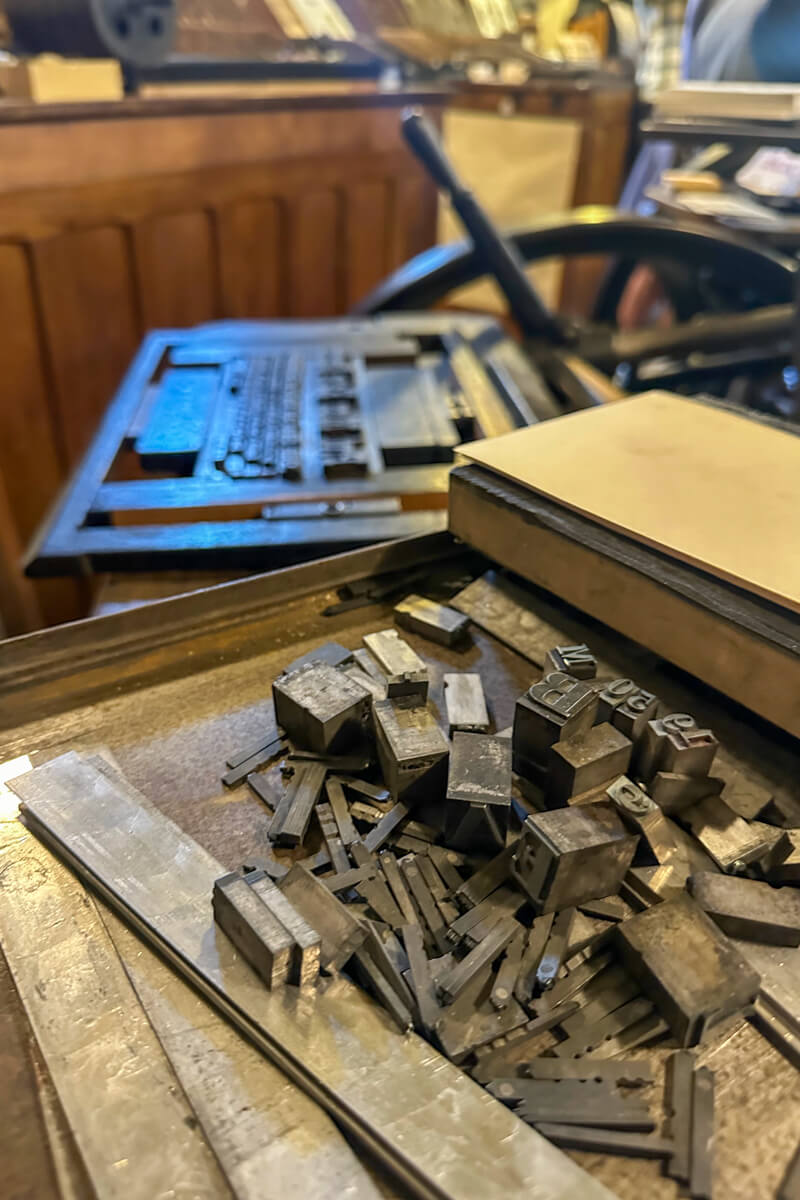 Printing letters in front of the vintage printing press