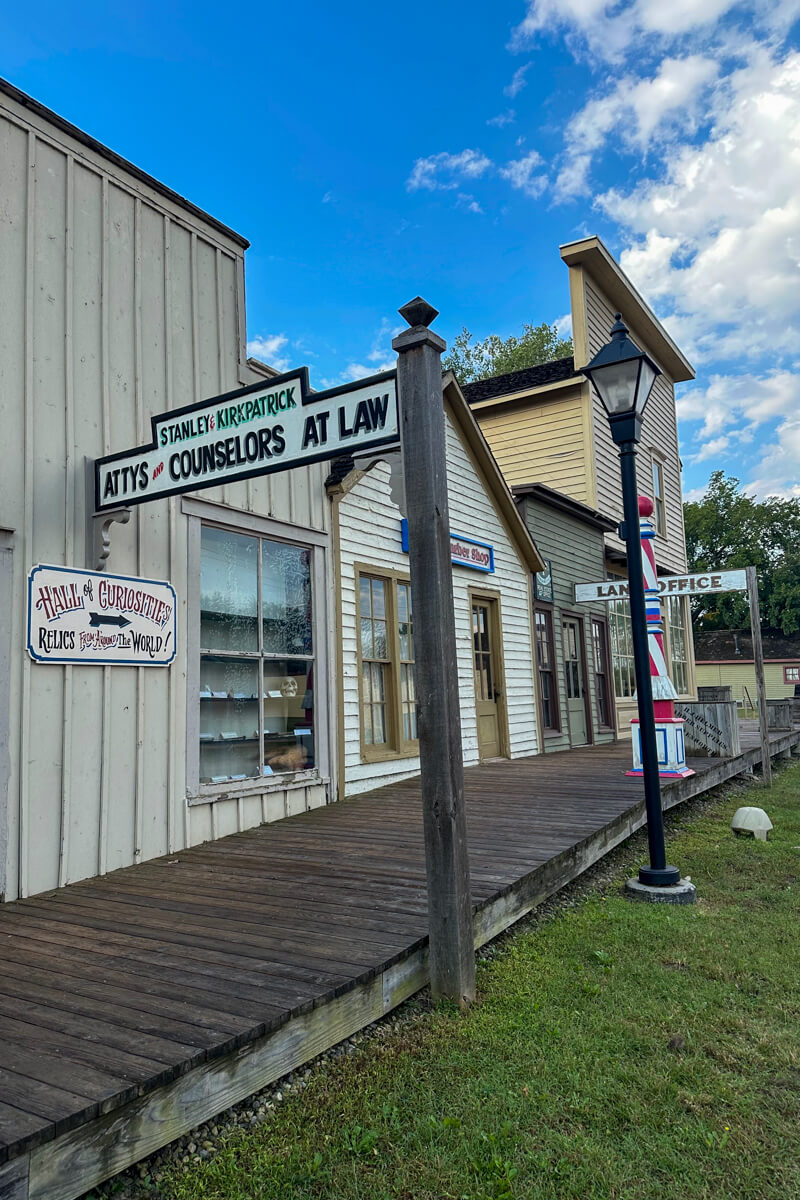 The board walk next to a line of stores/offices in Cowtown