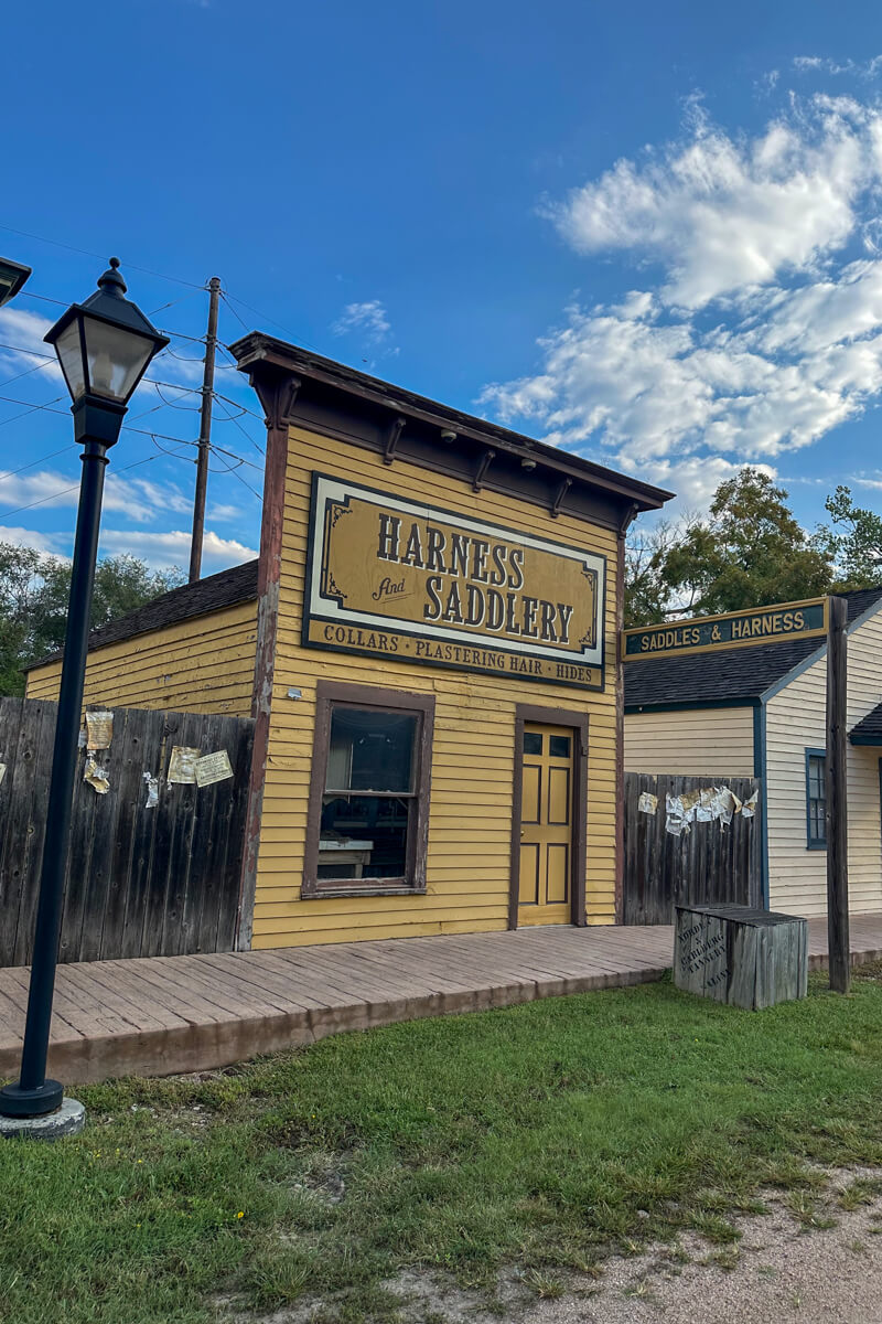 A street light and tan store front in Cowtown