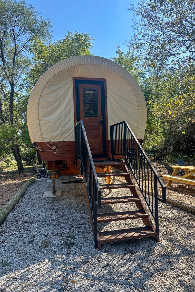 A small staircase leading up to a covered wagon