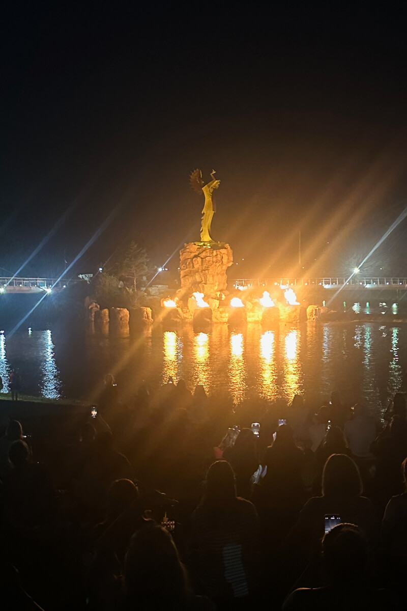 The Keeper of the Plains by night with fires lit