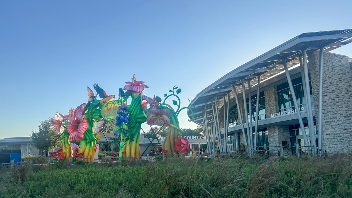 Colorful floral arrangement in front of the zoo in front of the main circular white building