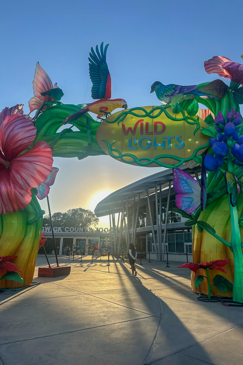 Colorful floral archway entrance to the zoo in front of the main circular white building