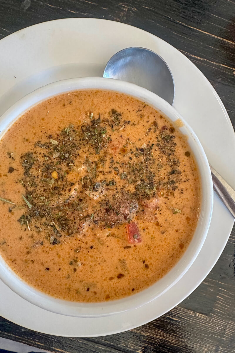 Overhead view of Tuscan tomato soup in a white bowl on a white plate