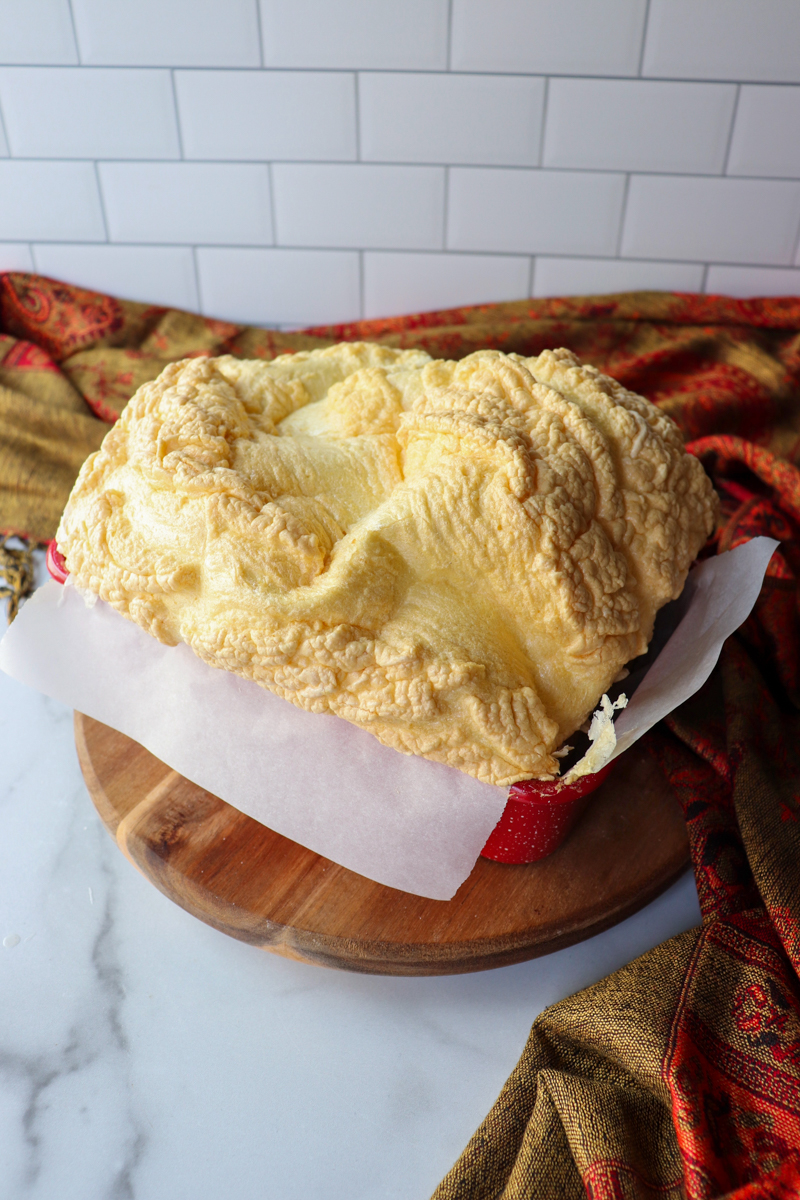Front side view of a loaf of egg white protein bread cooling in the pan