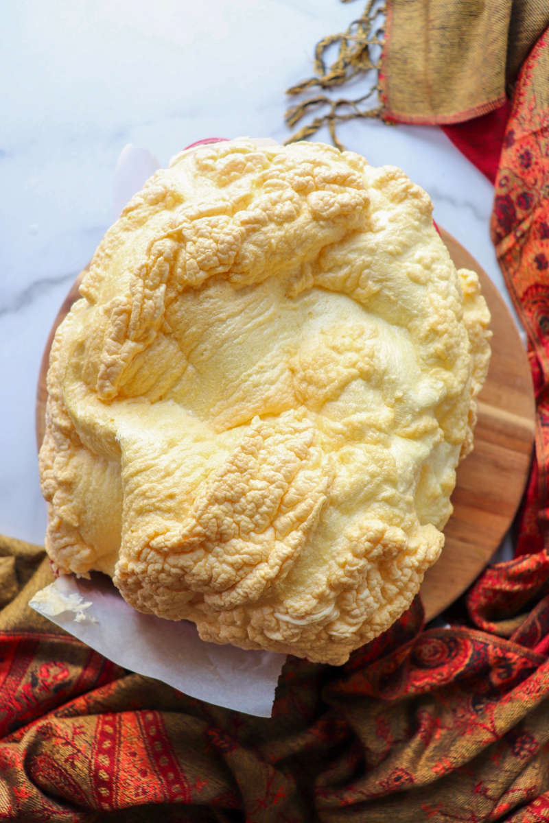 Overhead view of a loaf of egg white protein bread cooling in the pan