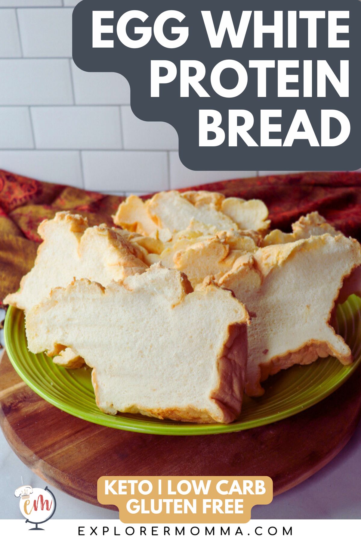 A green plate piled with slices of egg white protein bread on a wooden base with text overlay "Egg White Protein Bread"