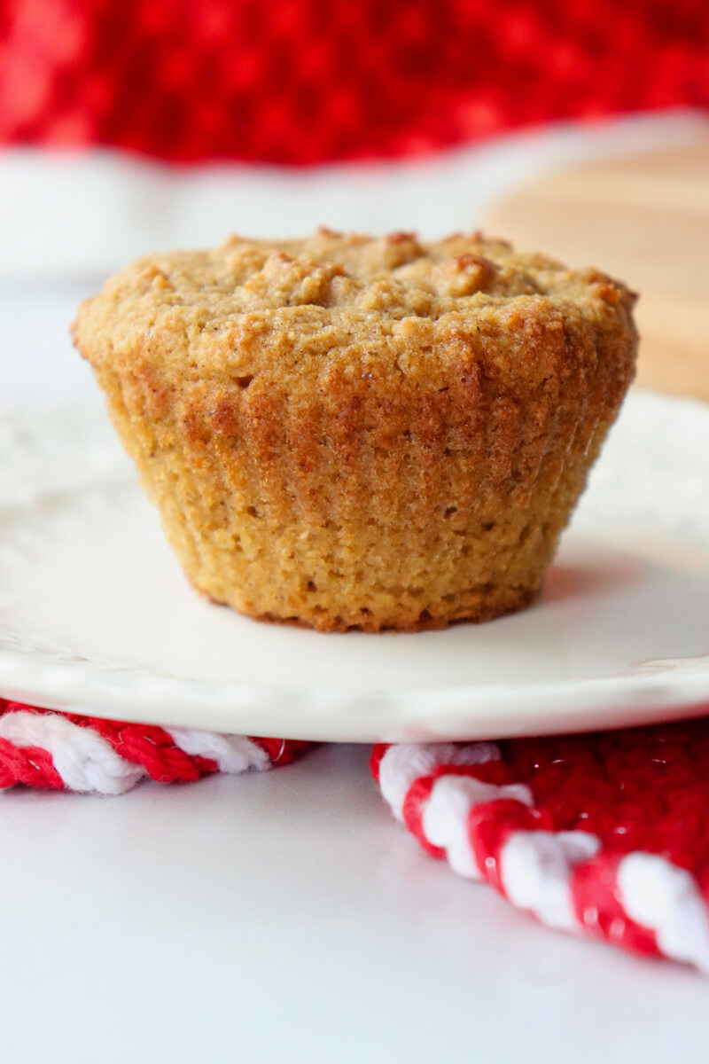 A front close up view of a low carb gingerbread muffin on a white plate