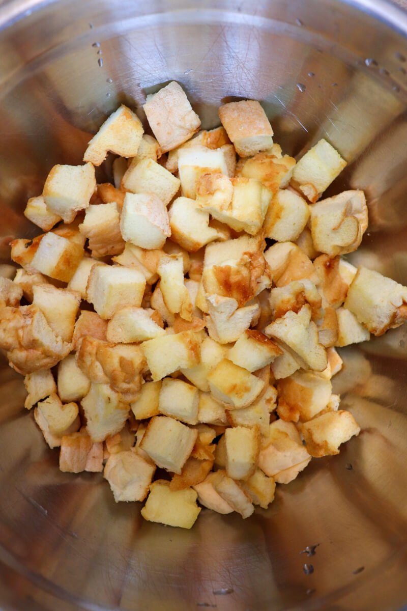 Overhead view of a metal bowl of the toasted cubed keto protein bread