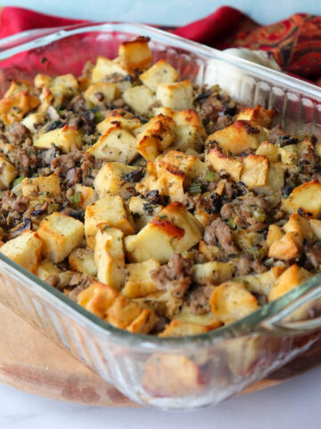 A glass Pyrex dish full of keto stuffing with sausage and protein bread