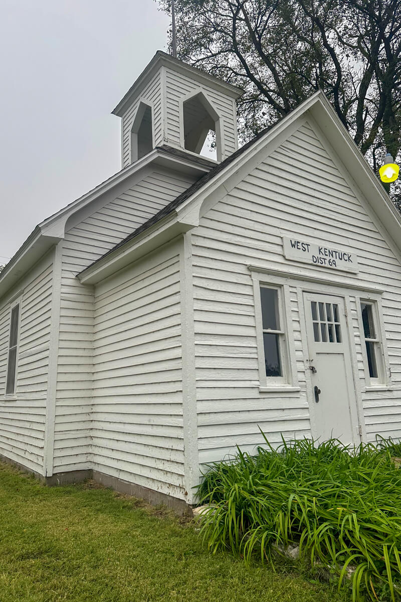 The front of the white traditional church at the Old Mill Museum