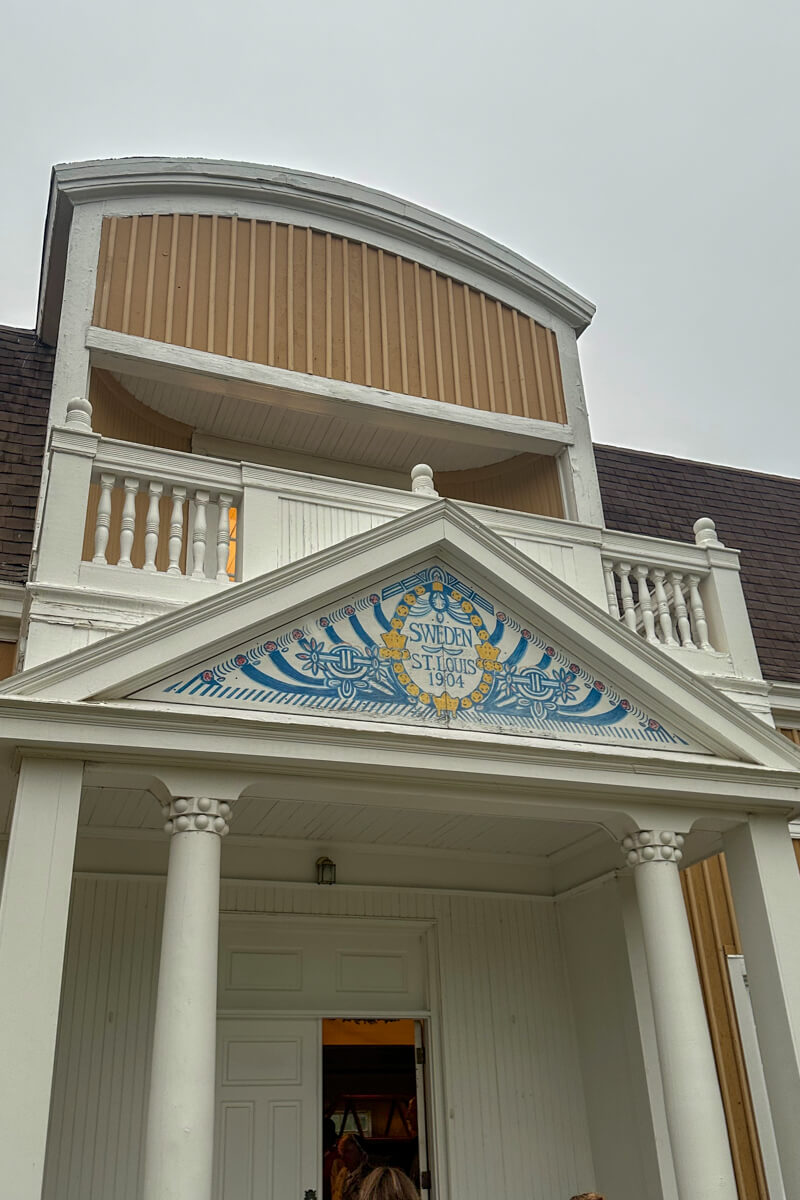The white and light blue painted front of the main hall in the Old Mill Museum with columns and decorations