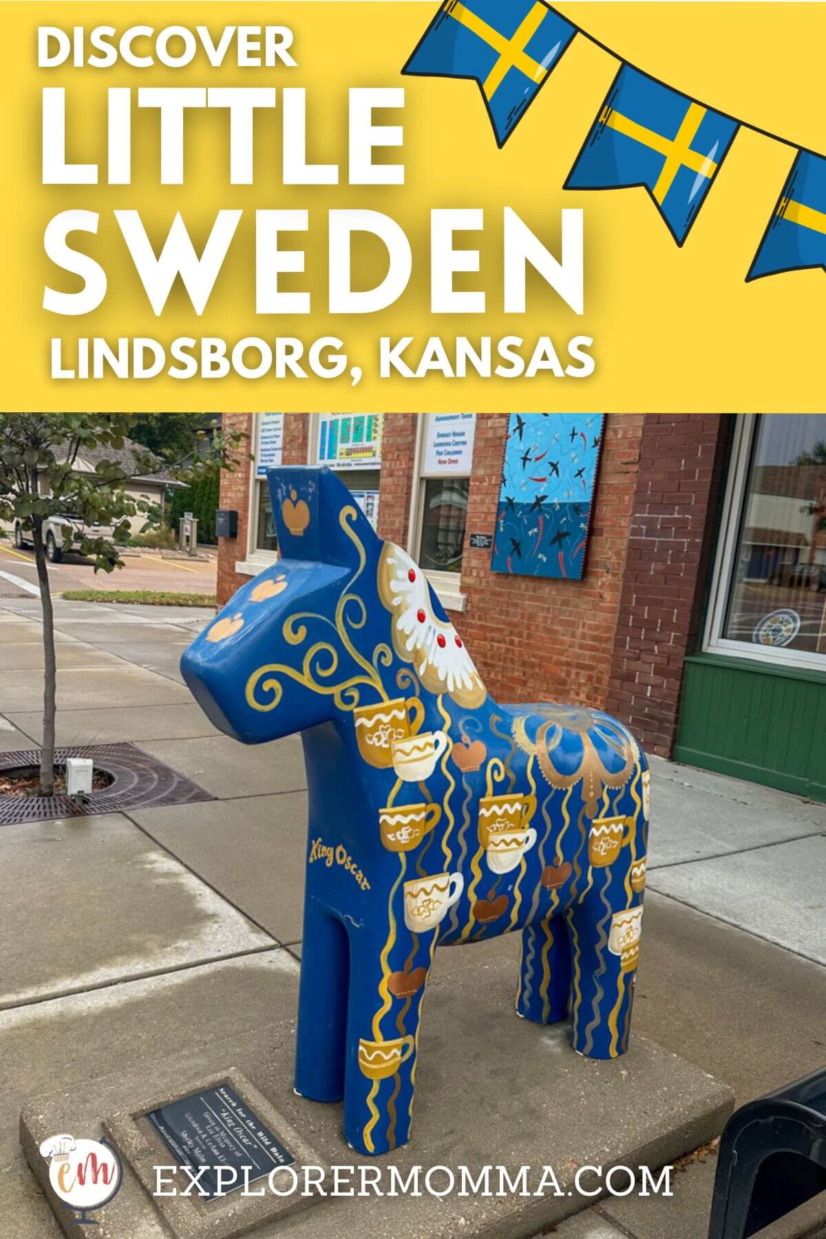 A blue Dala horse painted with coffee cups in front of a main street store with text overlay, "Discover Little Sweden, Lindsborg Kansas".