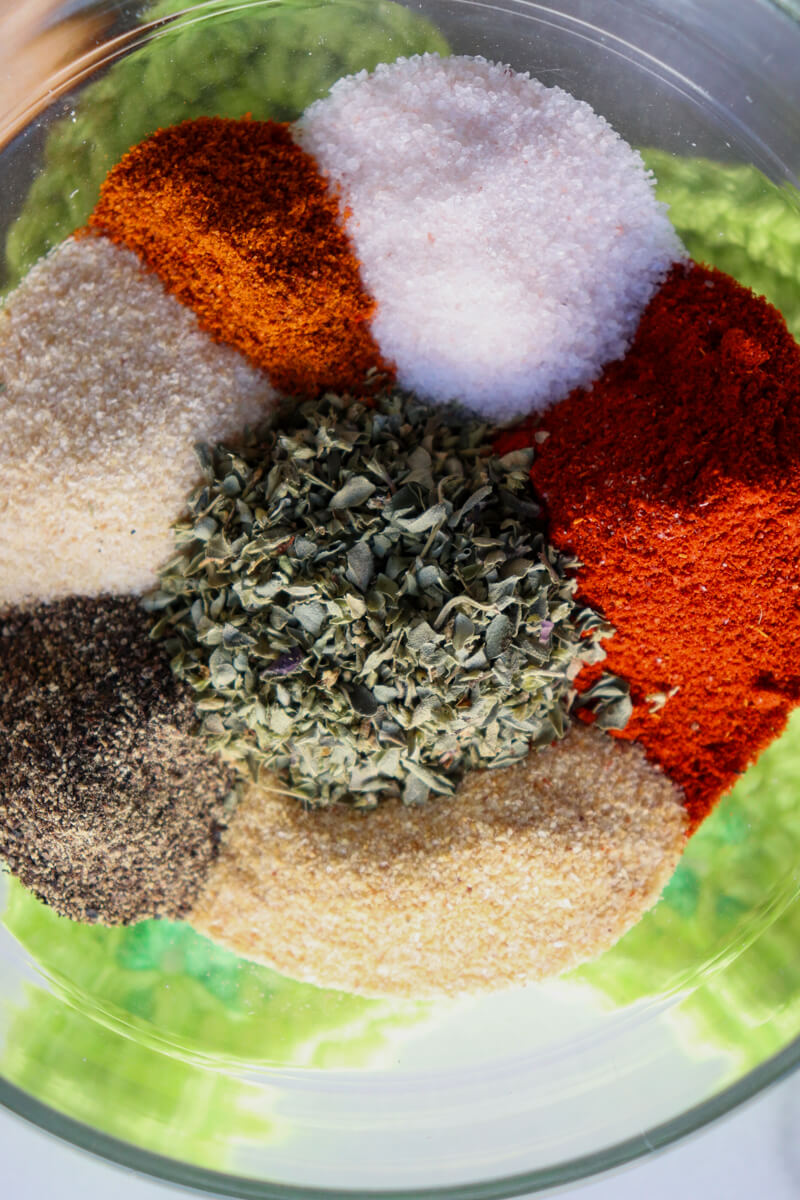 Closeup overhead view of colorful spices in the chicken taco seasoning on a yellow crocheted star coaster