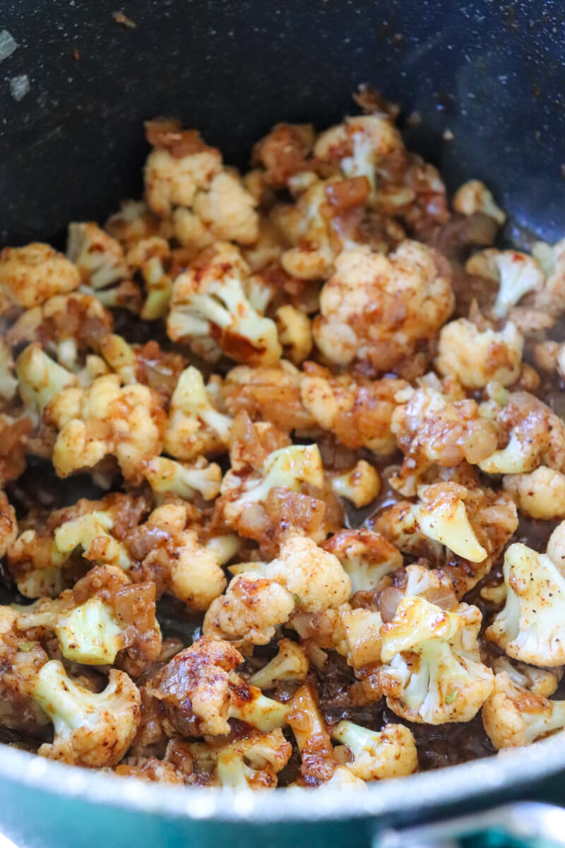 A pot of cooked cauliflower, etc. with spices.
