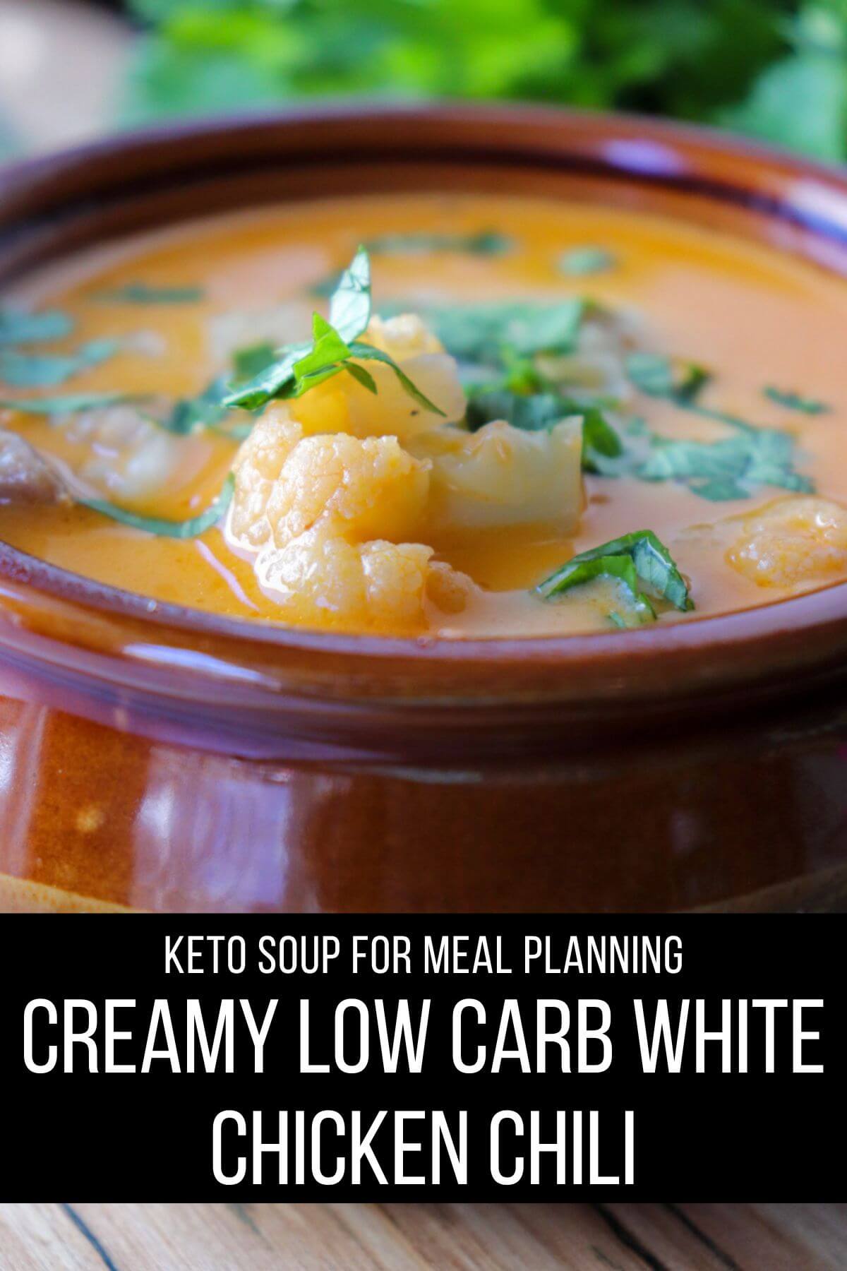 Front view of a brown ceramic bowl of keto white chicken chili with chopped cilantro. Text overlay: Creamy Low Carb White Chicken Chili, Keto | Gluten Free