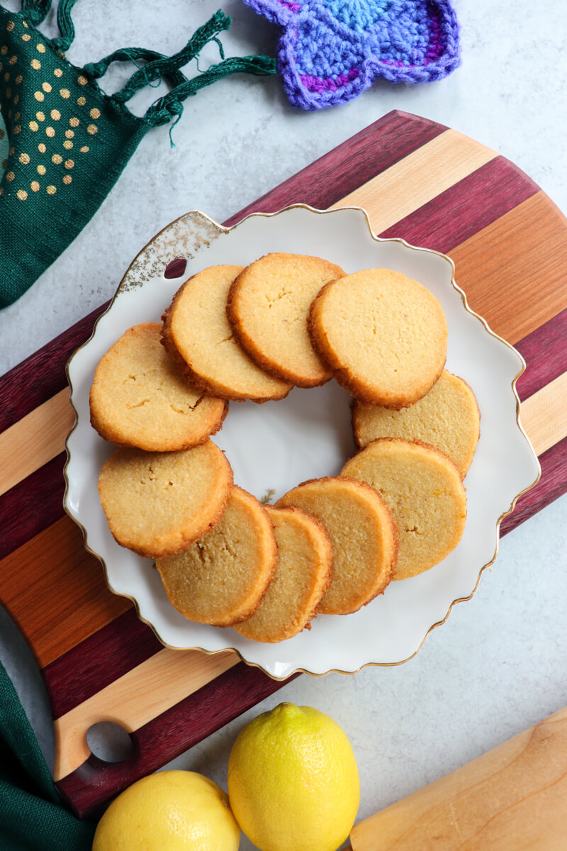 Overhead view of round gluten free shortbread cookies in a circle on a white plate
