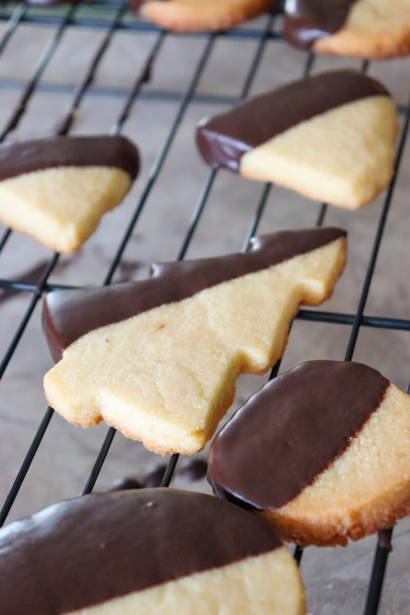 Gluten free shortbread cookies dipped in sugar free chocolate on a metal cooling rack