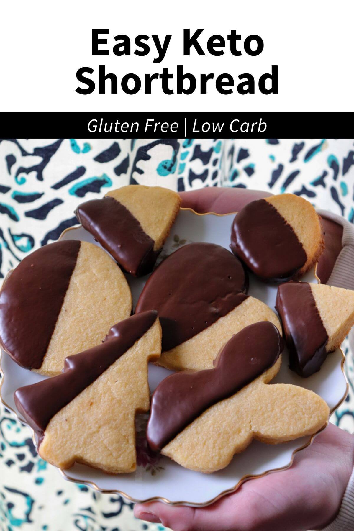 Two hands holding out a plate of gluten free shortbread cookies dipped in chocolate with text overlay "Easy Keto Shortbread, gluten free, low carb"