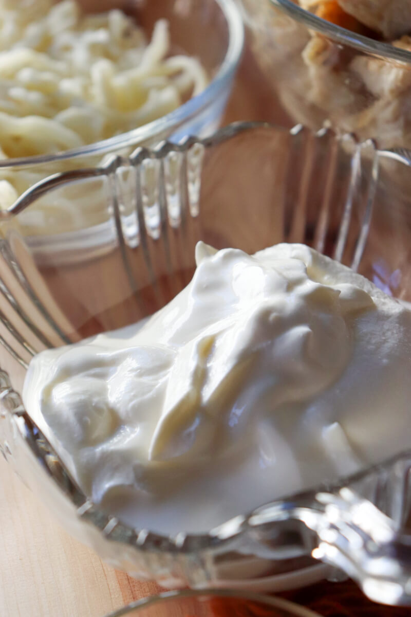 Small decorative glass bowl filled with sour cream